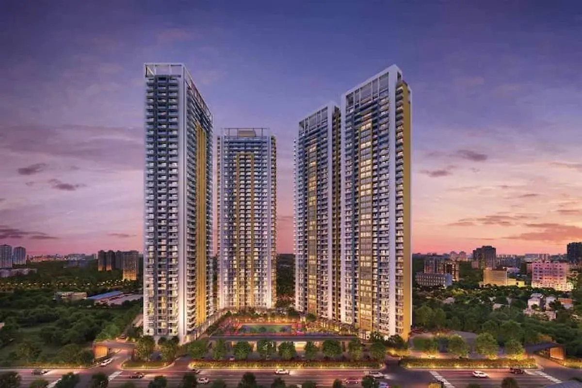 Luxury high-rise residential apartments with modern architecture, landscaped surroundings, and evening city skyline